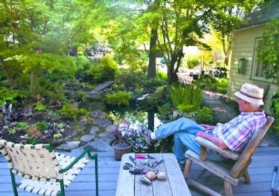 
After putting his tools aside for a short break, Steve Hoitink admires his backyard oasis. 
 (Photos by Christopher Anderson/ / The Spokesman-Review)