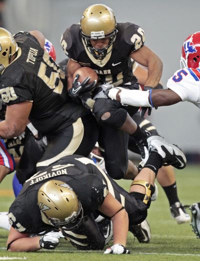 Idaho running back Princeton McCarty leaps over offensive lineman Tyrone Novikoff on Saturday. (Associated Press)