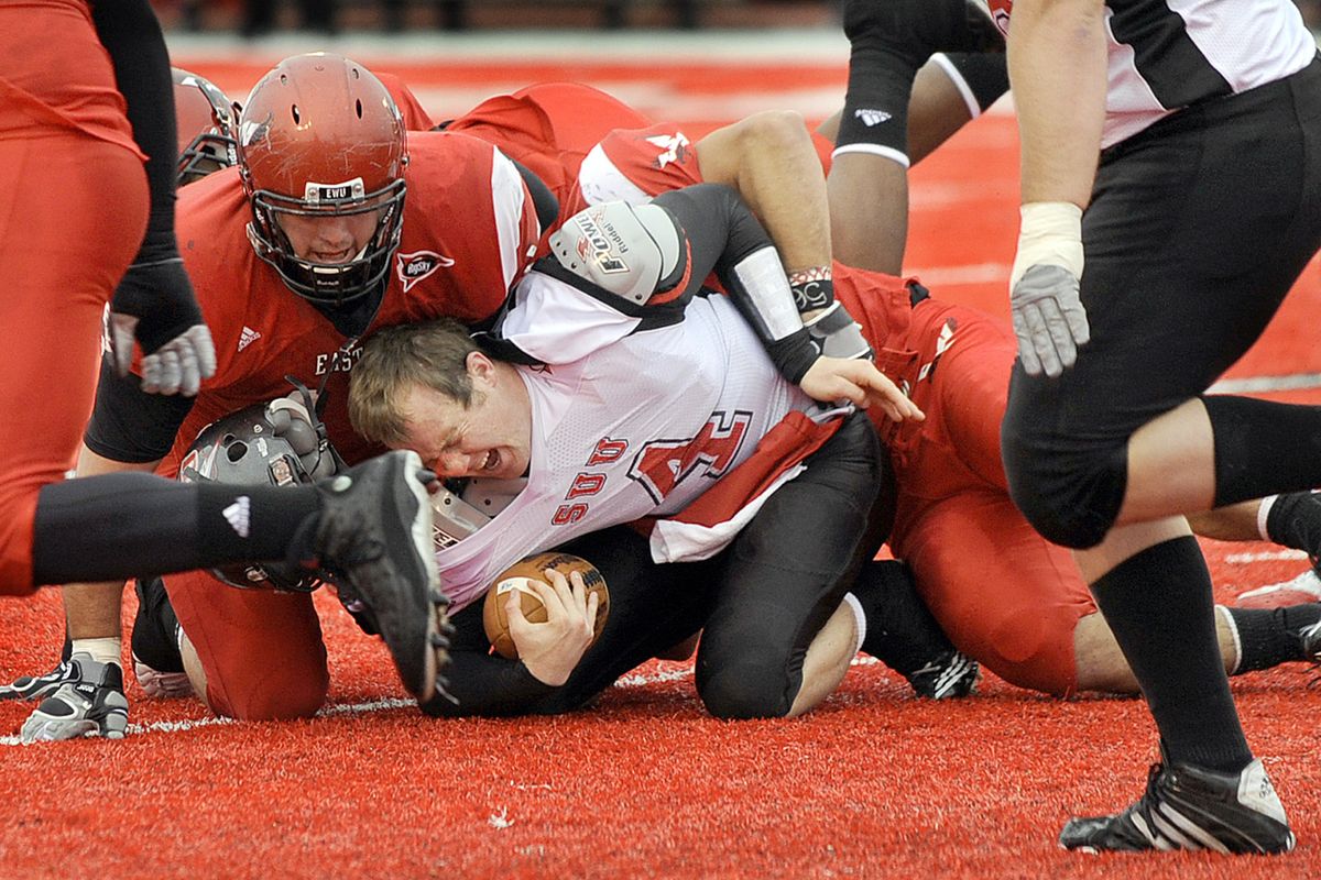 The EWU defense buries helmetless Southern Utah quarterback Brad Sorensen. (Christopher Anderson / The Spokesman-Review)