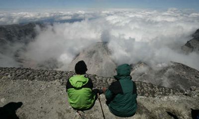 
 Members  of a news media climbing party sit  Thursday on the crater rim of Mount St. Helens. The trail will be reopened to the public Friday. 
 (Associated Press / The Spokesman-Review)