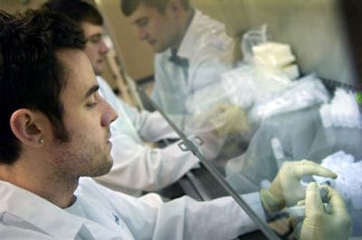 
Employees Nicholas Mulvaney, foreground, and Robert Fyall fill bottles with a chemical solution for Prime Alert biohazard detection kits at GenPrime, a Spokane biotech company.  GenPrime was started by two Eastern Washington University professors. 
 (Holly Pickett / The Spokesman-Review)