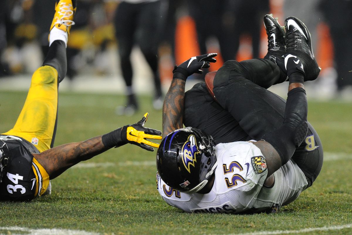 Baltimore Ravens linebacker Terrell Suggs intercepts a pass with his knees in the fourth quarter. (AP)