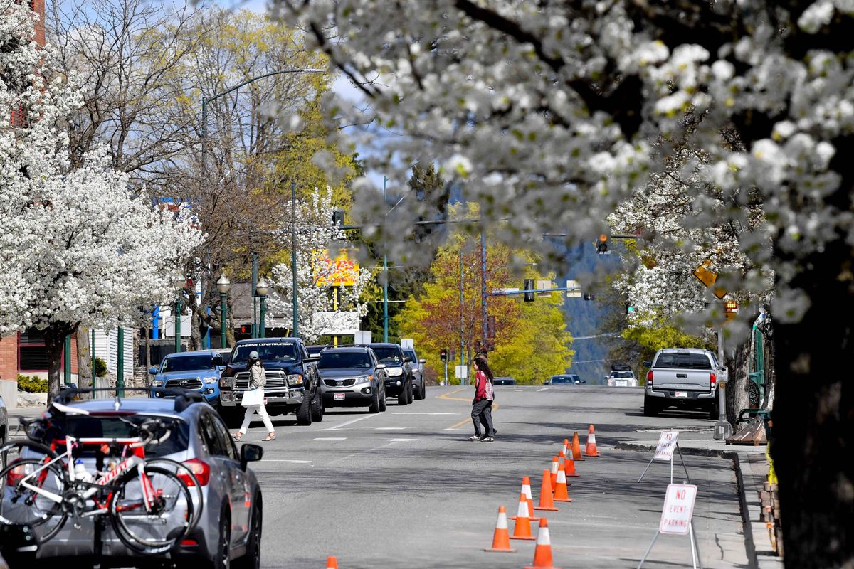 Pedestrians and cars make their way along Sherman Avenue in downtown Coeur d’Alene in April 2021.  (Tyler Tjomsland/The Spokesman-Review)