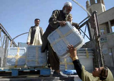 
Election workers on Thursday deliver the ballot boxes to a polling station in Kabul, Afghanistan, where security is on high alert as the country's first democratic presidential election nears.
 (Knight Ridder / The Spokesman-Review)