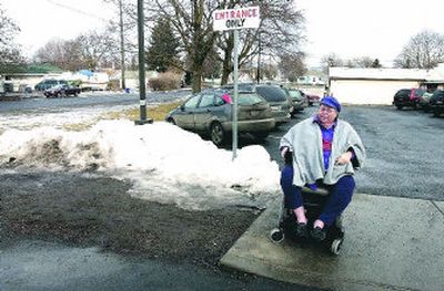 
Sandra Lampe-Martin sits in her electric wheelchair outside of Pratt Elementary where the sidewalk turns into gravel. The Parent Teacher Group president  also volunteers at Edgecliff SCOPE, and she has to travel in the street to get there after she leaves the school. 
 (J. BART RAYNIAK / The Spokesman-Review)