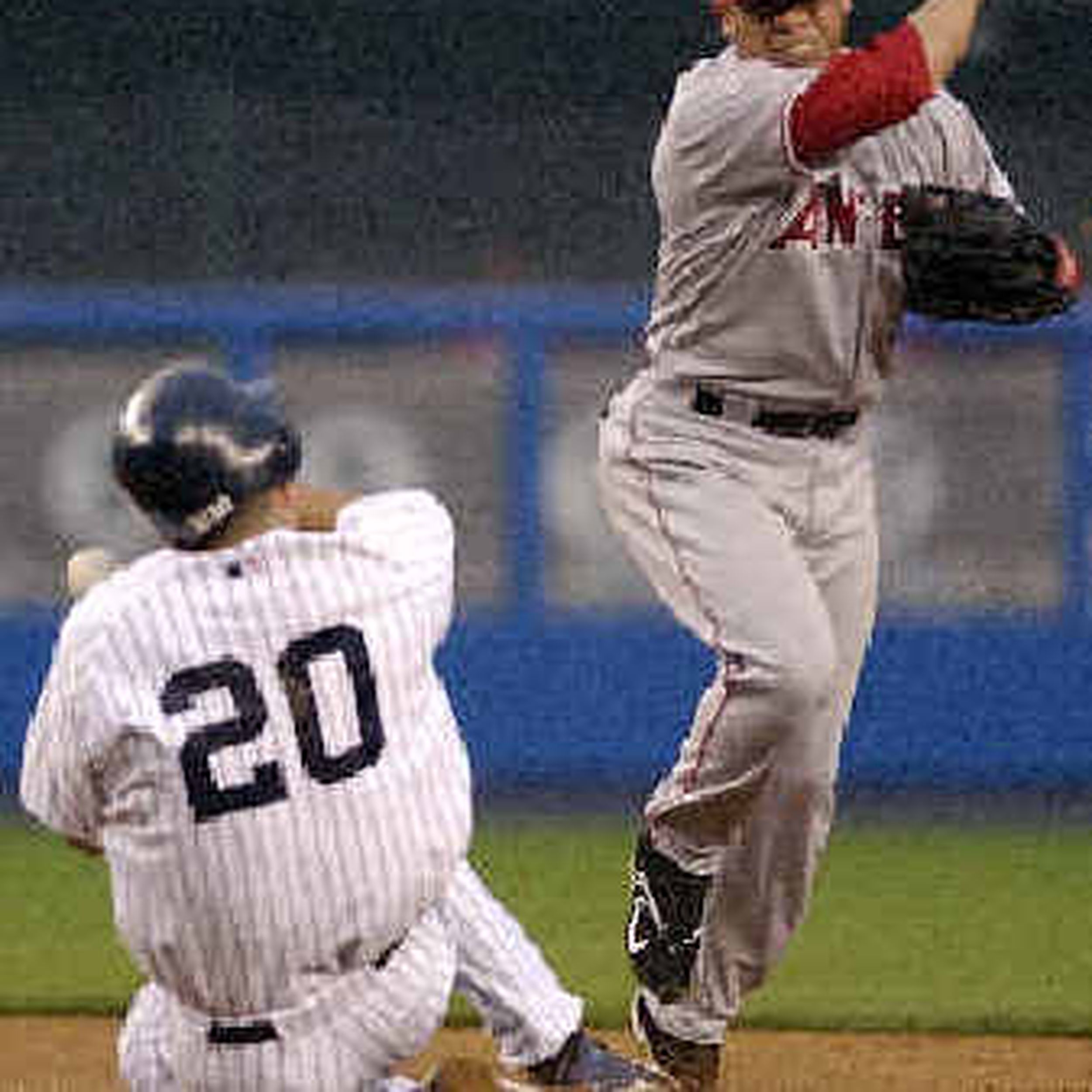 New York Yankees catcher Jorge Posada just misses Alex Gonzalez of