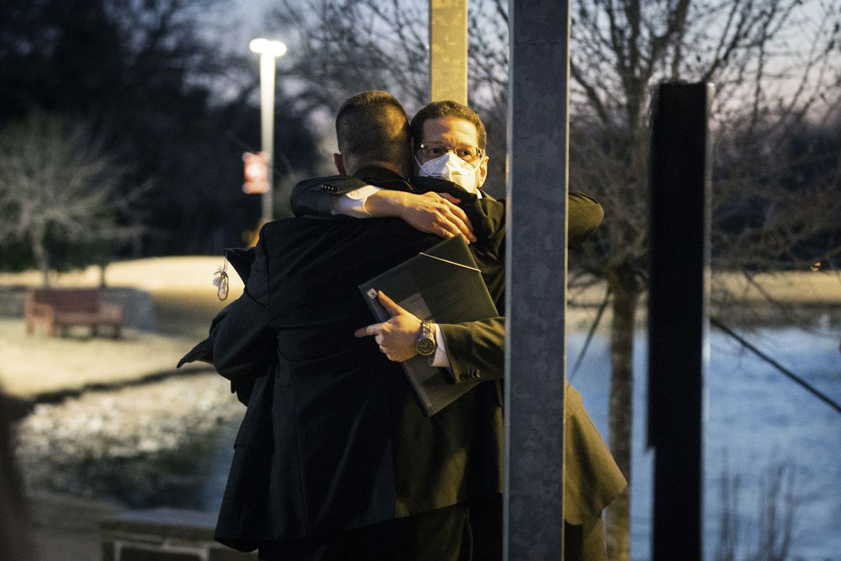 Congregation Beth Israel Rabbi Charlie Cytron-Walker, facing camera, hugs a man after a healing service Monday night, Jan. 17, 2022, at White