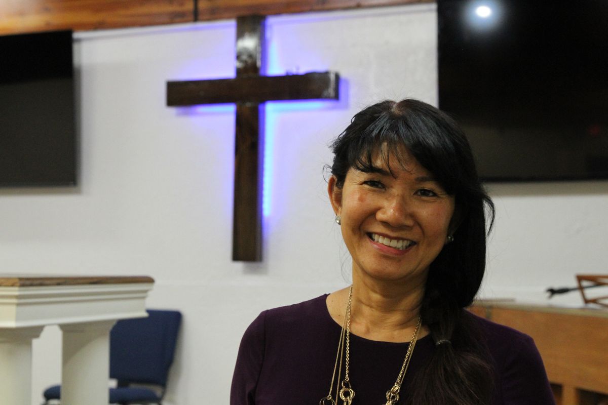In this May 24, 2021, photo, Linda Dunegan poses for a photo in the sanctuary of the Open Door Baptist Church in Anchorage, Alaska. Dunegan purchased a former strip club and leased the main floor to the church.  (Mark Thiesssen)