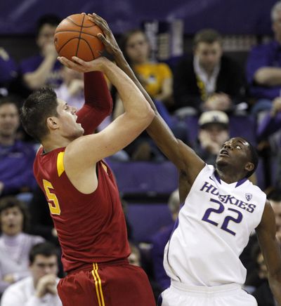 Washington's Justin Holiday blocks a shot by USC Nikola Vucevic in the first half of Saturday’s game. (Associated Press)