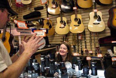 
Double Eagle Pawn employee Brooke Ryan, right, helps customer Terry Hanson of Spokane Valley look at camera lenses at the 3030 E. Sprague store in Spokane. Pawnshops in the Inland Northwest are in the midst of the Christmas shopping season. 
 (Holly Pickett / The Spokesman-Review)