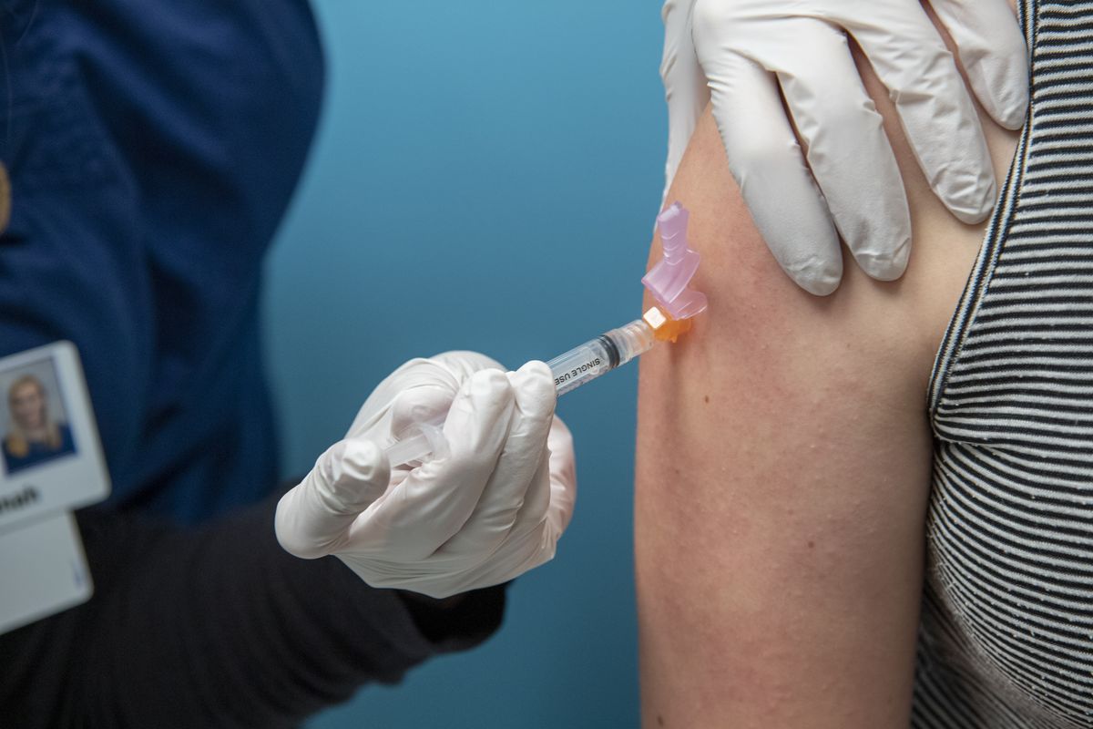 An incoming sixth-grader gets immunizations at Rockwood Pediatrics Wednesday, July 15, 2020. New rules for immunizations for Spokane Schools students include medical verification of all shots and the extension of the Dtap vaccine through high school.  (Jesse Tinsley/The Spokesman-Review)