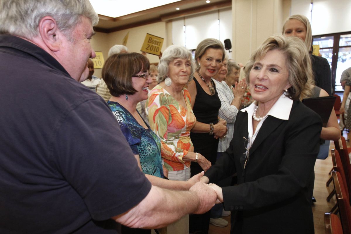 FILE — In this Oct. 13, 2010, file photo former California U. S. Senator Barbara Boxer shakes hands with supporters during a campaign stop in Lincoln, Calif. Boxer was assaulted and robbed Monday July 26, 2021, in the Jack London neighborhood of Oakland, Calif. A statement on Boxer