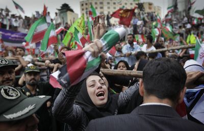 A female supporter reacts, as tens of thousands of supporters of Iranian President Mahmoud Ahmadinejad gather in Vali Asr square for a rally attended by the president on Sunday.  (Associated Press / The Spokesman-Review)