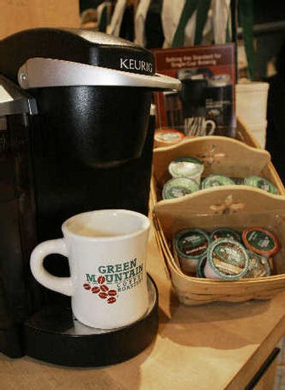 
A single-serving coffee maker is seen at the Green Mountain Coffee Roasters outlet store in Waterbury, Vt. The dimunitive cups are a self-contained coffee brewing system that can be popped into a relatively new brand of coffee maker to produce a single cup of steaming java. 
 (Associated Press / The Spokesman-Review)