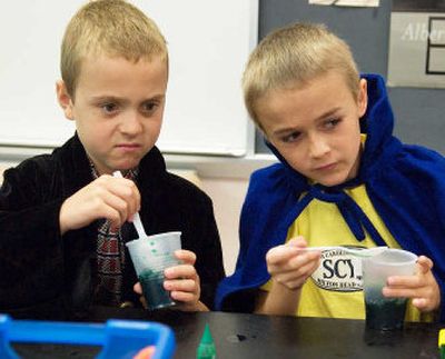 
Charlie Halsey, left, and Sam Curran mix while pretending to make magic potions at the Harry Potter camp at the South Street School in New Canaan, Conn. 
 (Associated Press / The Spokesman-Review)