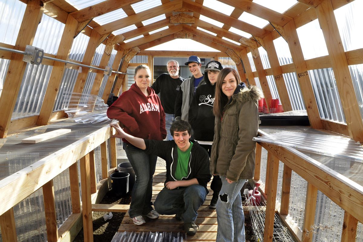 Teacher Robbie Robinson, second from left, stands in a greenhouse with Harmony High School students, from left, Satieva Ankley, Josh Armstrong, Chris Kinyon, Cody Buchanan and Franki Turner. (Dan Pelle)