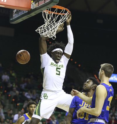 Baylor forward Johnathan Motley, scores over John Brown forward Brenton Toussaint and forward Benjamin Smith, right, in the second half of an NCAA college basketball game, Sunday, Dec. 18, 2016, in Waco, Texas. (Rod Aydelotte / Waco Tribune-Herald via AP)