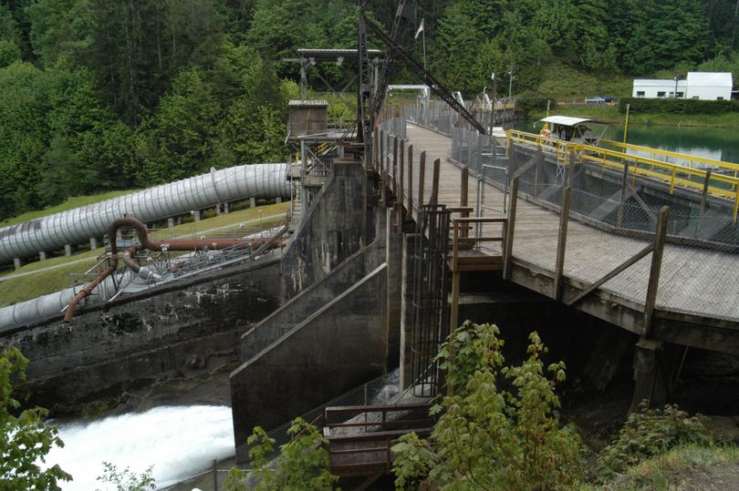 In this  May 21 photo, water pours over the spillway of the Elwha Dam west of Port Angeles, Wash. (Associated Press)