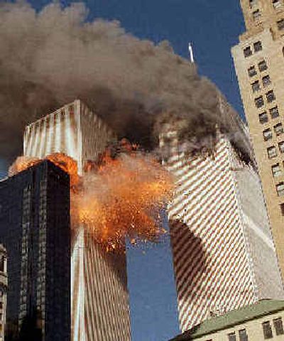 
Smoke billows from one of the towers of the World Trade Center as flames and debris explode from the other on Sept. 11, 2001.
 (Associated Press / The Spokesman-Review)