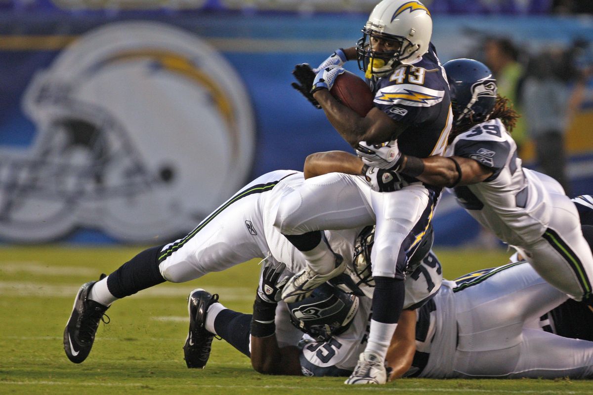 Chargers running back Darren Sproles is wrapped up by C.J. Wallace of the Seahawks after a short gain.  (Associated Press / The Spokesman-Review)