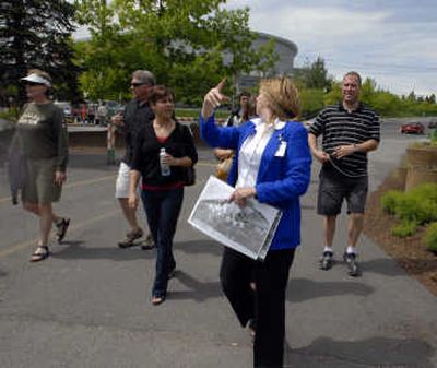 Spokane City Tours owner Susan Bauguss  talks about the Spokane Arena as she walks guests to the Spokane Falls in Riverfront Park on Sunday.
 (J. Rayniak / The Spokesman-Review)