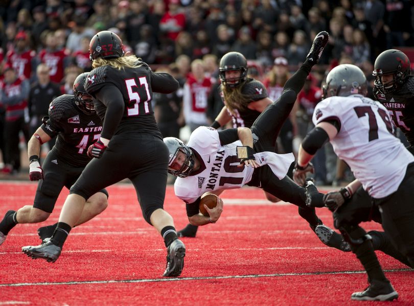 Montana Grizzlies quarterback Jordan Johnson (10) is tackled for a loss in the first half of an NCAA college football game, Saturday, Nov. 8, 2014, in Cheney, Wash. (Colin Mulvany / The Spokesman-Review)