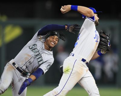 Kansas City Royals second baseman Chris Owings, right, turns a double play after forcing out Seattle Mariners’ Mallex Smith, left, during the fourth inning of a baseball game at Kauffman Stadium in Kansas City, Mo., Wednesday, April 10, 2019. (Orlin Wagner / Associated Press)