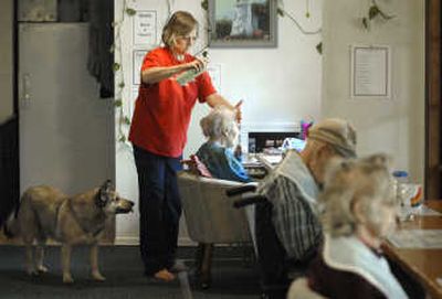 
Carol Carroll fixes the hair of Norma Peer, 90, before breakfast Saturday at Carol's Care Adult Family Home  in Spokane Valley.  A state requirement that makes adult family homes carry costly liability insurance has put Carroll's home in jeopardy. 
 (Dan Pelle / The Spokesman-Review)