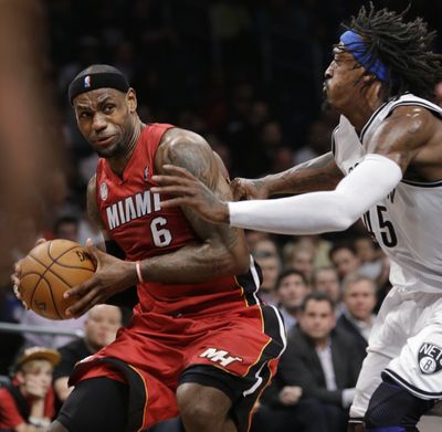 LeBron James, working against the Nets’ Gerald Wallace, commands attention, and respect, when he has the ball and is on the move. (Associated Press)