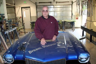 Butch Reilly, who teaches auto mechanics at Spokane Community College, stands in the hood of the class project car. The car races regularly at Spokane Raceway Park.
(PAUL DELANEY / The Spokesman-Review)