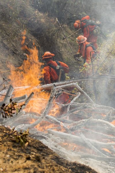 A fire crew works on a fire line as a wildfire burns just north of the San Gabriel Valley community of Glendora, Calif., on Thursday. (Associated Press)