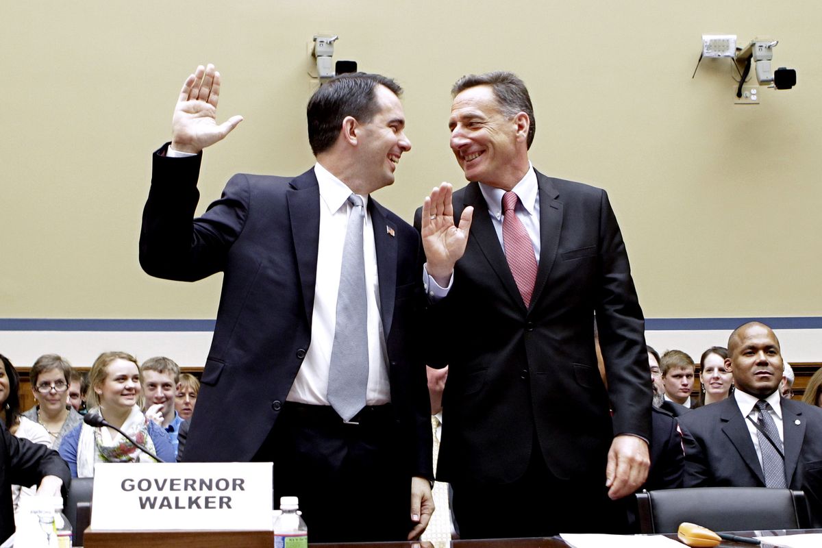 Wisconsin Gov. Scott Walker, left, and Vermont Gov. Peter Shumlin share a laugh Thursday prior to being sworn in before the House Oversight and Government Reform Committee. (Associated Press)