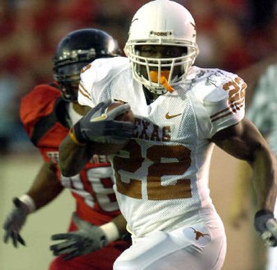 
Texas' Selvin Young gains yards against Texas Tech during the first half.
 (Associated Press / The Spokesman-Review)