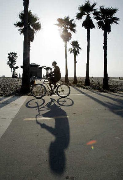 
A bicyclist pedals down the bike path adjacent to the boardwalk in the Venice Beach area of Los Angeles. 
 (The Spokesman-Review)
