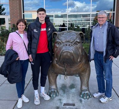 Alex Toohey (center) poses in front of a bulldog statue on Gonzaga’s campus with his parents during a recent visit to Spokane. The Australian wing became the second player to sign with Mark Few’s Zags in the 2023 recruiting class.  (Courtesy/Michael Toohey)