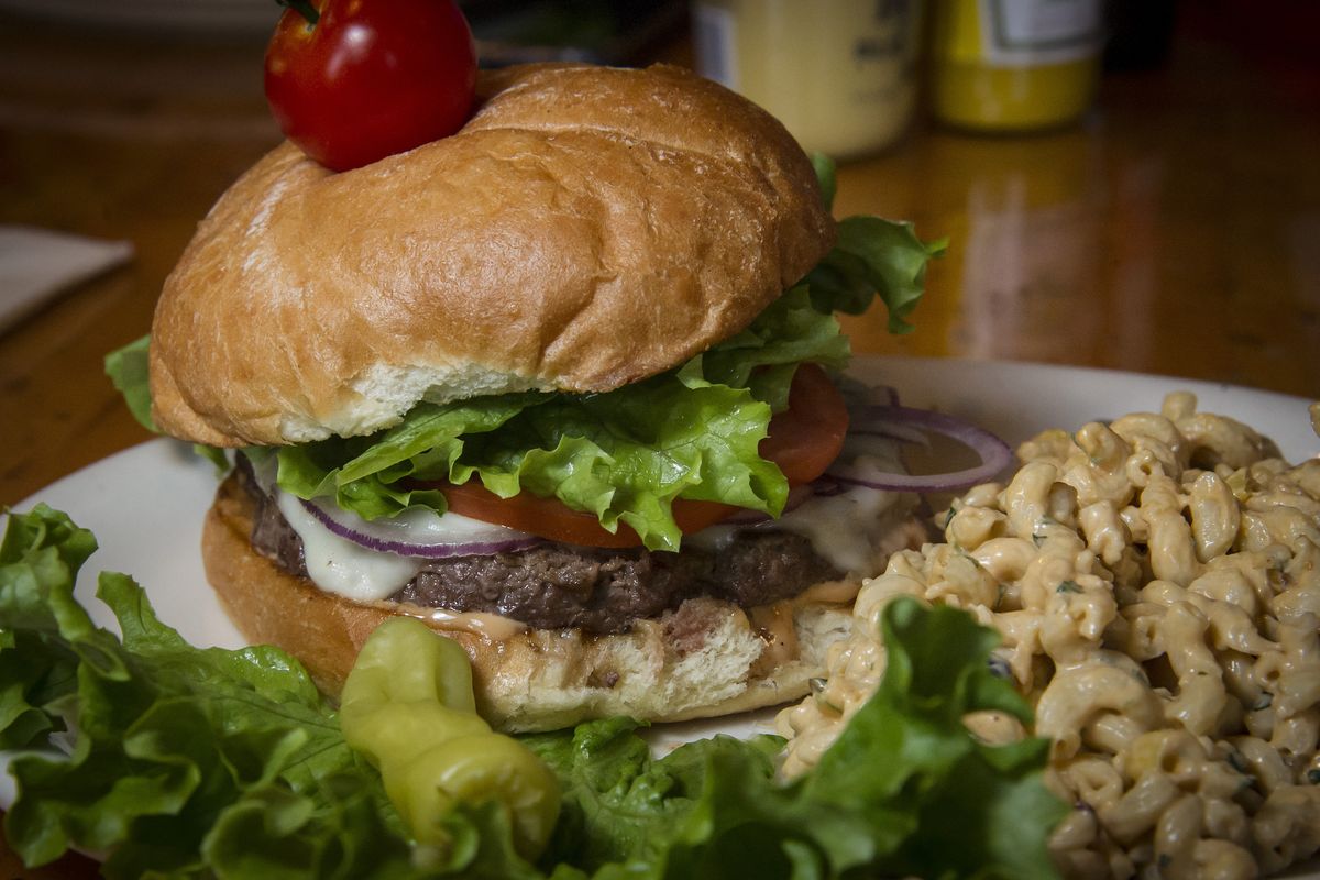 The Reindeer Burger at the Elk Public House is made with farm-raised reindeer from Alaska. The cherry tomato on top pays homage to Rudolph the Red-Nosed Reindeer. (Colin Mulvany)