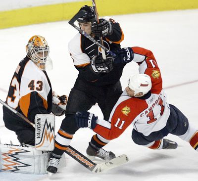 Flyers’ Randy Jones, center, and goalie Martin Biron are playoff bound.  (Associated Press / The Spokesman-Review)