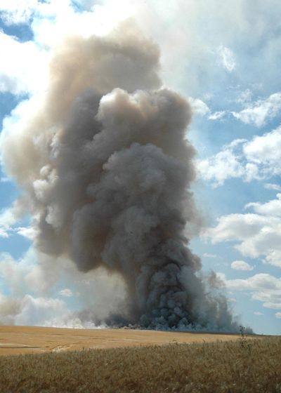 The stubble of a grain field on the Camas Prairie is burned after the harvest, producing a heavy plume of smoke Aug. 6, 2009, in Lewiston, Idaho. (Barry Kough / Lewiston Tribune)
