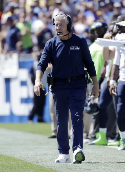 Seattle Seahawks coach Pete Carroll, walking the sideline during the first half of Sunday’s game in Los Angeles, has been fined $200,000 for violating the NFL’s work rules on contact in the offseason. (Jae Hong / Associated Press)