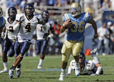 UCLA's Kahlil Bell breaks up the middle for a 64-yard gain in the second quarter. Associated Press
(Associated Press / The Spokesman-Review)