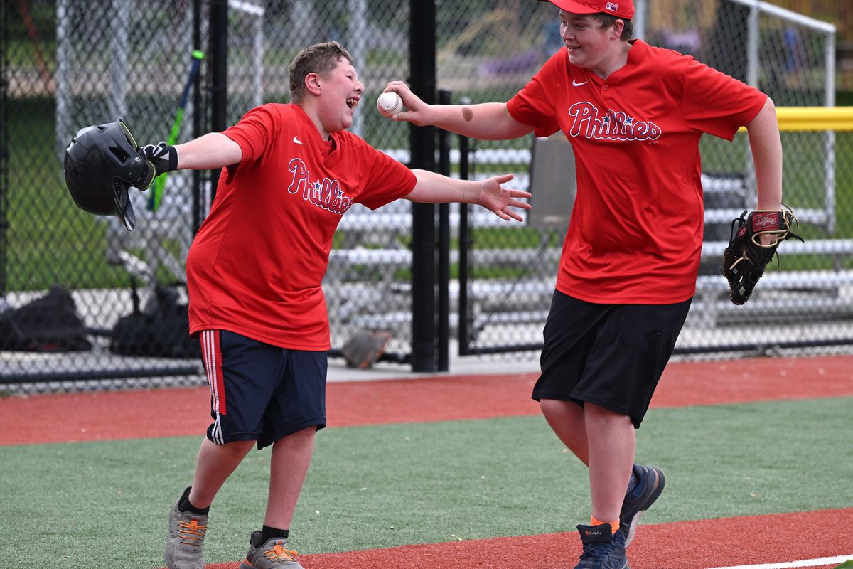 Ace James, left, 15, is playfully chased from third to home by teammate Nate Cook, 13, as James takes his run of the bases after batting practice on May 29 at the adaptive baseball field located at Mission Park in Spokane. The friends are part of a team in the Bambino Buddy Ball league for young people with developmental delays to learn the basics of the game.  (Jesse Tinsley/THE SPOKESMAN-REVIEW)