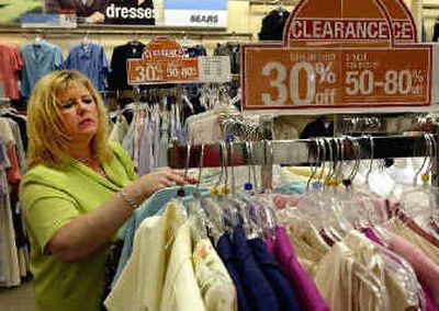 
A customer looks over clearance items at a Sears store in suburban St. Louis. Sears, Roebuck and Co. posted Thursday a $61 million loss in the third quarter. 
 (Associated Press / The Spokesman-Review)