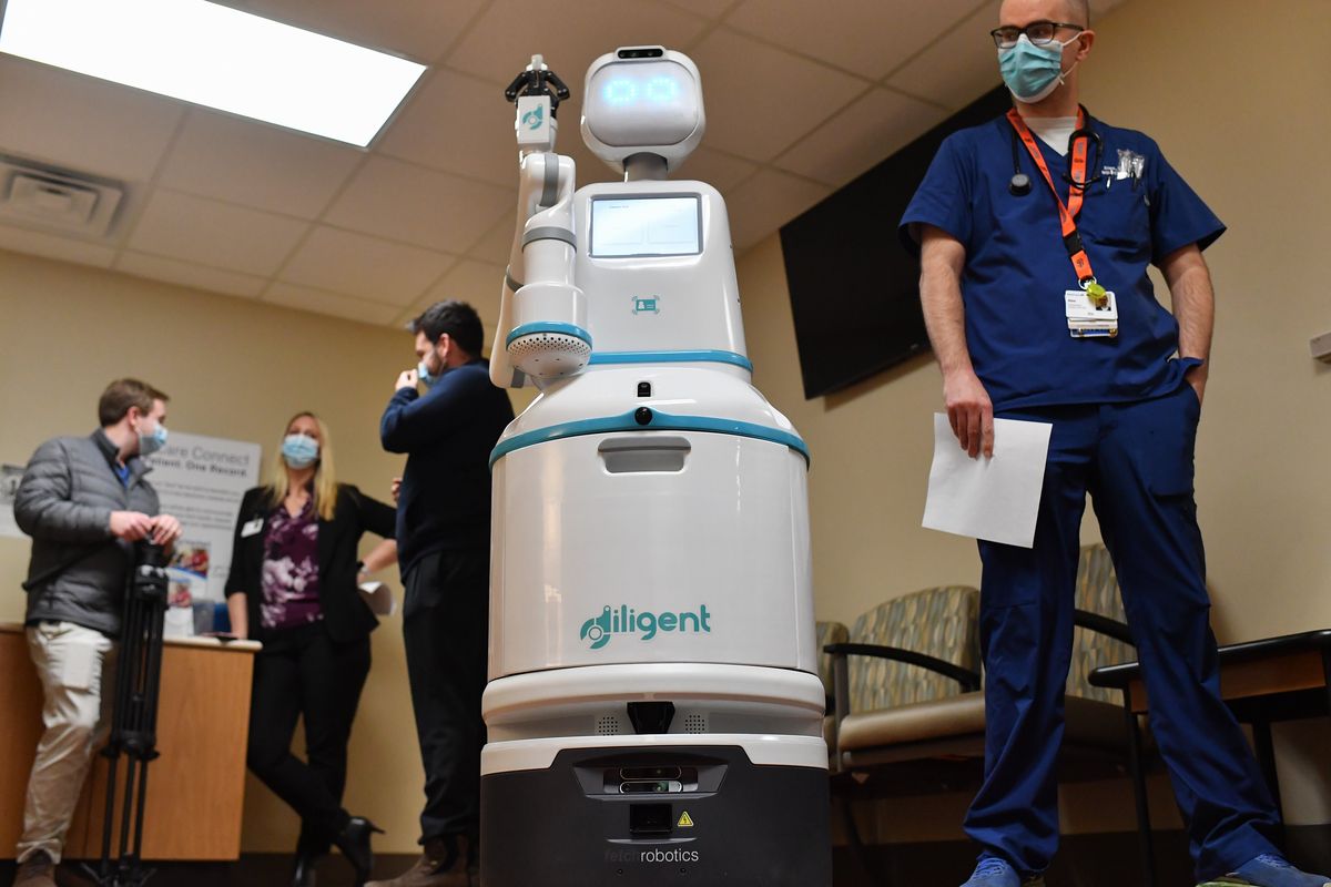 RN Alex Bare checks out one of Deaconess’ four new Moxi robots on Thursday, Jan 2023, at MultiCare Deaconess Hospital in Spokane, Wash. Moxi, created by Diligent Robotics, will serve as an aid to nurses and will not have patient interaction or go into patient rooms. Some of its duties include delivering lab samples and running patient medications, supplies and other items for patient care.  (Tyler Tjomsland/The Spokesman-Review)