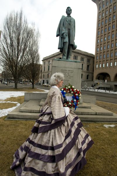 Annie Pierce of the Daughters of the American Revolution in Spokane spent two weeks sewing a period dress to celebrate the 200th anniversary of President Abraham Lincoln’s birth on Thursday. She was part of a wreath-laying ceremony at the city’s Lincoln statue at Main Avenue and Monroe Street.  (Colin Mulvany / The Spokesman-Review)