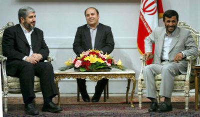 
Iran's President Mahmoud Ahmadinejad, right, meets with exiled Palestinian Hamas leader Khaled Mashaal, left, during a meeting in Tehran, Iran, on Sunday.
 (Associated Press / The Spokesman-Review)