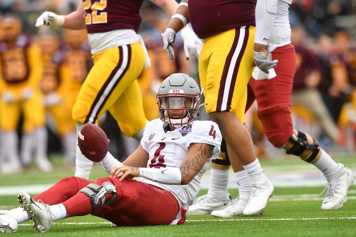 Washington State quarterback Jayden de Laura (4) reacts after being sacked by Central Michigan defensive lineman Thomas Incoom (9) during the first half of the Cougars