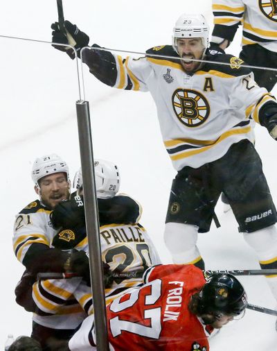 Bruins Andrew Ference, left, and Daniel Paille celebrate the game-winning goal. (Associated Press)