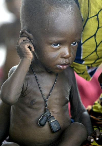 
An unidentified malnourished child sits Tuesday next to his mother at a feeding center in Maradi, Niger.
 (Associated Press / The Spokesman-Review)