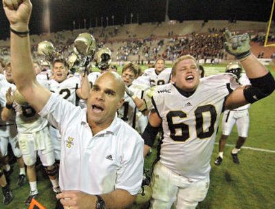 
Idaho coach Nick Holt celebrates with his team after its dramatic double-overtime victory over New Mexico State. 
 (Associated Press / The Spokesman-Review)