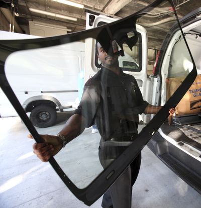 Tim James, of Pittsburgh Glass Works, carries a sun-reflecting windshield for display at a meeting of the California Air Resources Board in Sacramento, Calif., on Thursday.  (Associated Press / The Spokesman-Review)